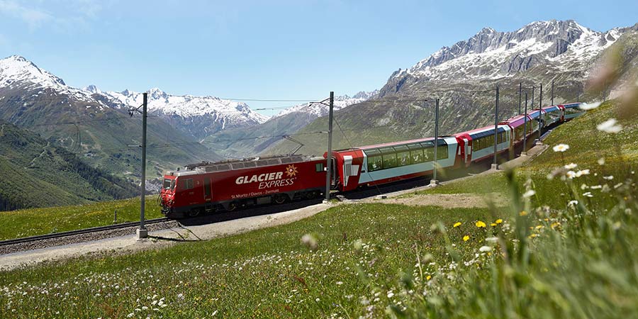 A view of the Swiss Alps, snow-capped peaks against a clear sky